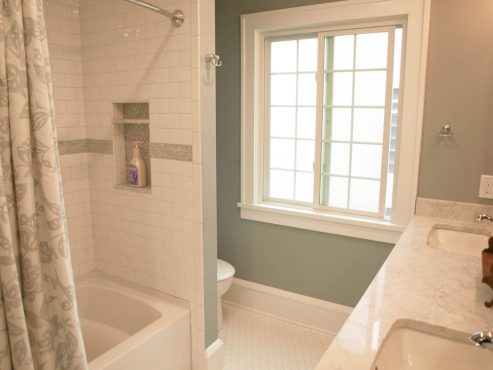 The tub was relocated to the interior wall of the bathroom, creating an alcove for the toilet and allowing for the installation of an alcove tub.