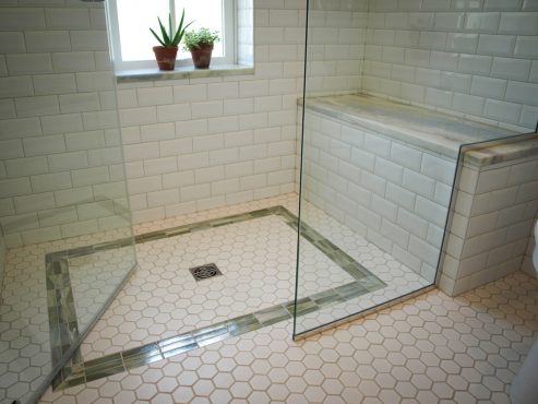 Custom glass shower enclosure with door that swings in or out!