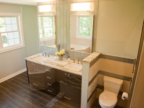 The chocolate-stained, custom-built vanity coordinates perfectly with the porcelain tile floors.