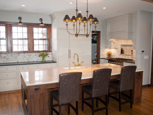 The Hudson Valley Jasper chandelier adds warmth and character to the newly renovated space, seamlessly integrating the kitchen into the rest of the first floor.