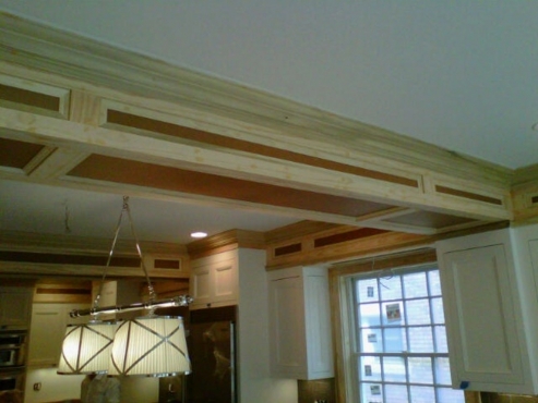 Custom woodwork on soffits to copy the door profile of the cabinets.