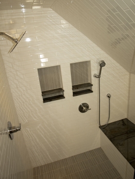 The Adex Neri white 2x8 ceramic tile one the walls and ceiling of the shower create a bright space, making the shower feel larger.